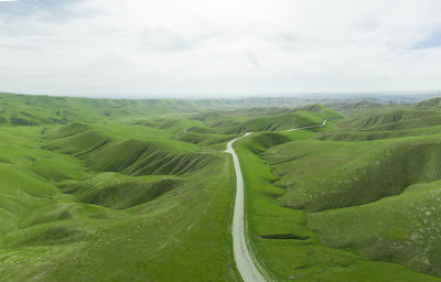 Green rolling hills idyllic scene in california after heavy spri