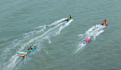 High angle view of people boating at sea