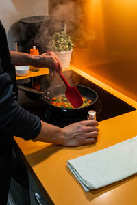 Midsection of man preparing food on table