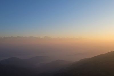 Scenic view of silhouette mountains against sky during sunset