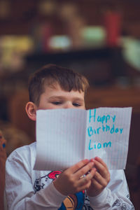 Portrait of boy holding text