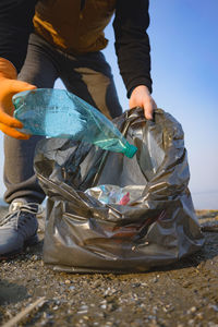 Midsection of man holding garbage