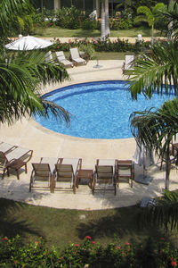 Chairs by swimming pool in park