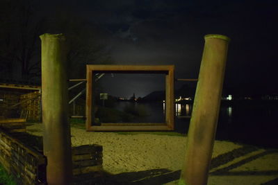 Illuminated built structure against sky at night