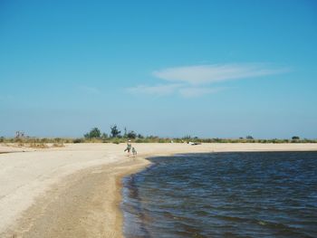 Scenic view of beach against blue sky