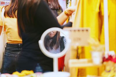 Midsection of people standing in store