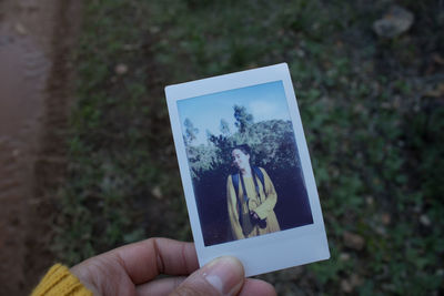 Close-up of person holding camera