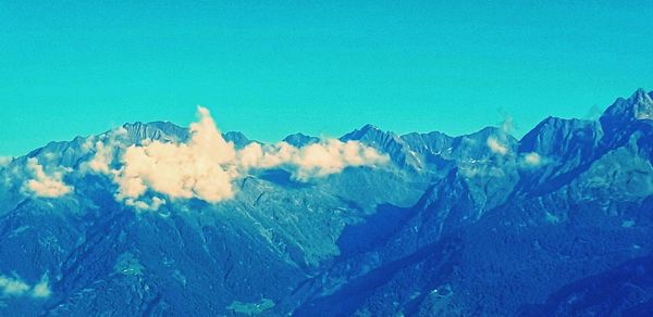 Panoramic view of mountains against clear blue sky