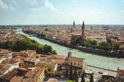 High angle view of canal amidst buildings in town