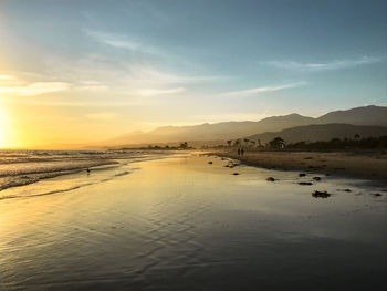 Scenic view of beach against sky during sunset