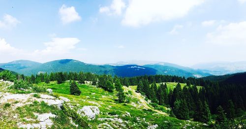 Scenic view of mountains against cloudy sky