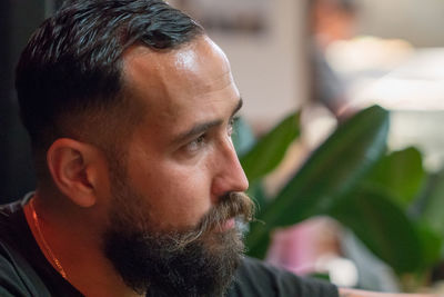 Close-up of thoughtful bearded man looking away