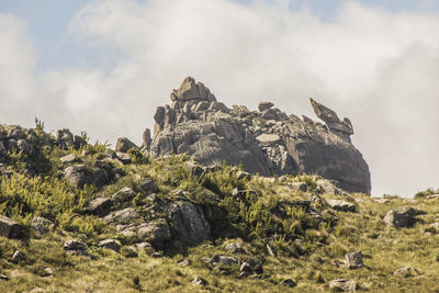 Rock formations on landscape against sky