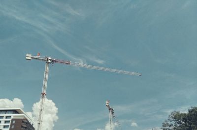 Low angle view of crane against sky