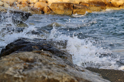 Waves splashing on rocks at shore