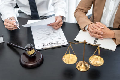 Midsection of business colleagues working at table
