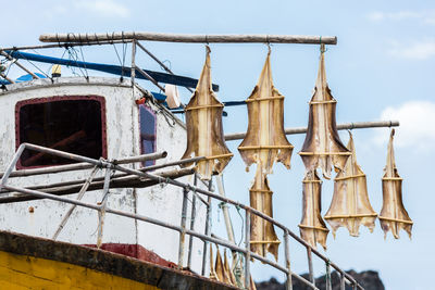 Low angle view of rope hanging against sky