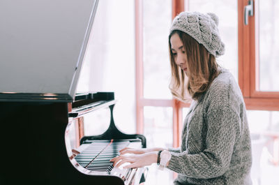 Beautiful woman playing piano