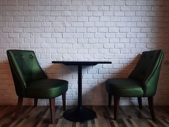 Empty chairs and table against wall at home