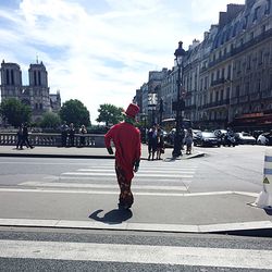 Full length of woman walking on city street