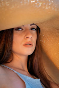 Young beautiful woman with big summer hat