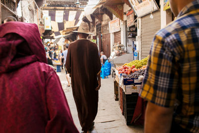 Rear view of people at market stall