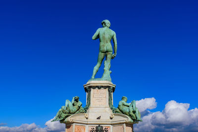 Low angle view of statue against blue sky