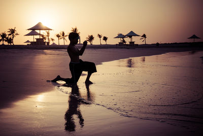 People on beach at sunset