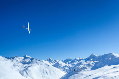 Scenic view of snowcapped mountains against clear blue sky