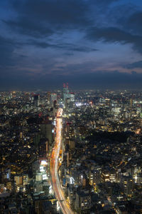 High angle view of illuminated city against sky at night