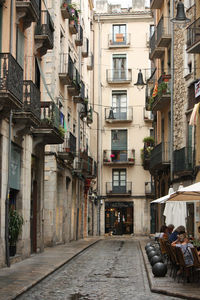 Footpath amidst buildings in city