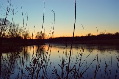Scenic view of lake against sky during sunset