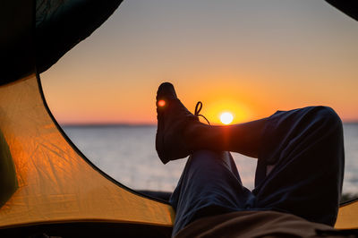 Midsection of silhouette man against sky during sunset