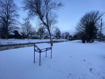 Scenic view of snow covered field against sky