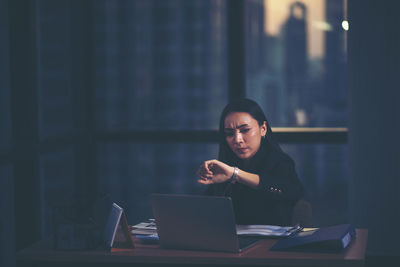 Woman working on table at home