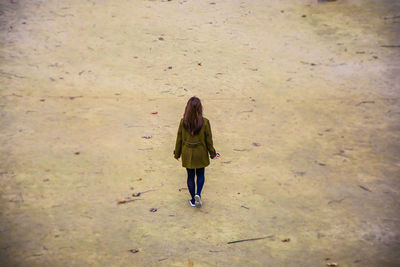 Full length of woman standing by railing