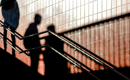 Shadow of person on staircase against wall