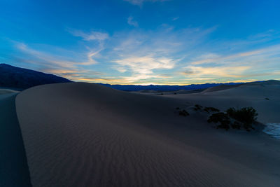 Scenic view of desert against sky during sunset