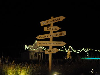 Information sign on grass at night