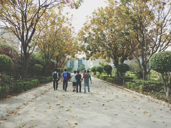 Rear view of woman walking on footpath