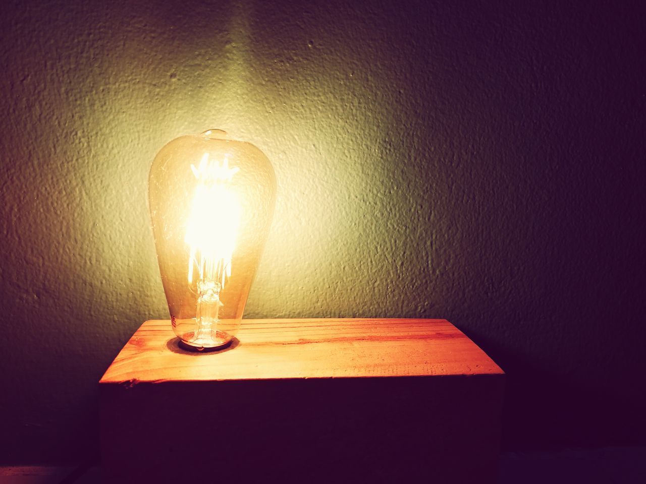 ILLUMINATED LIGHT BULB ON WALL