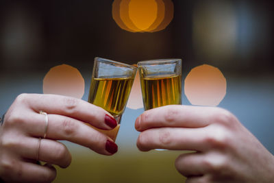 Close-up of woman holding beer glass