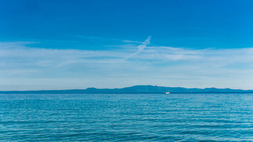 Scenic view of sea against blue sky