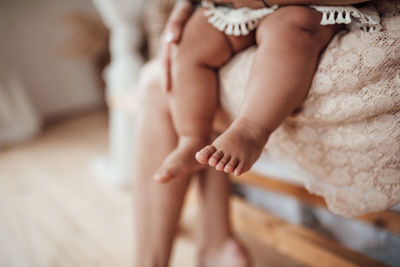 Low section of woman relaxing on floor