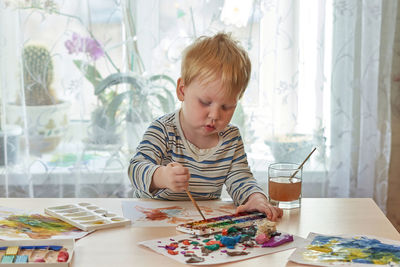 Boy sitting on table