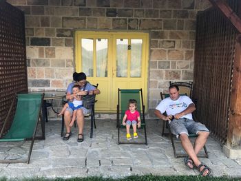 Family resting on porch