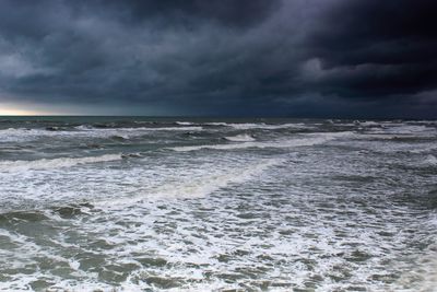 Scenic view of sea against storm clouds