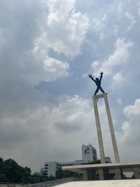 Low angle view of statue against cloudy sky