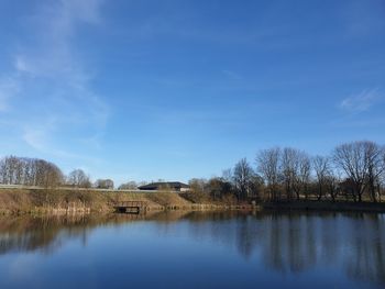 Scenic view of lake against blue sky