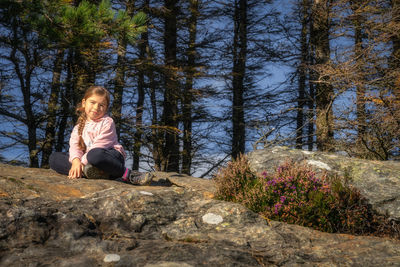 Portrait of woman sitting on rock